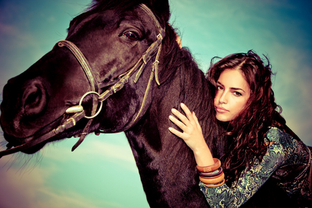 beautiful young woman on a horseback, outdoor portraitの写真素材