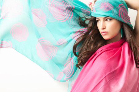 young beauty with blue pink scarf over her head, studio shotの写真素材