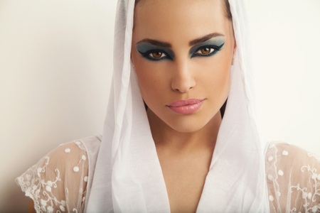 beautiful woman portrait with seductive makeup and white veil over her head, studio whiteの写真素材