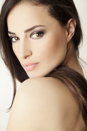 beauty face portrait, young woman with brown eyes and hair, studio whiteの写真素材