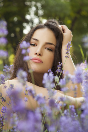 beautiful young woman in lavender field, outdoor closeup portraitの写真素材