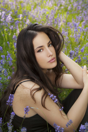 beautiful young woman in lavender field, outdoor closeup portraitの写真素材
