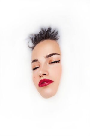 dreaming beauty in a milk bath, face portraitの写真素材