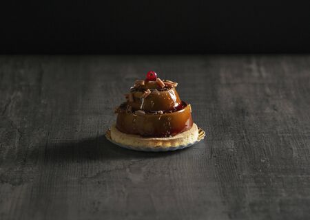 stylish beautiful caramel cake with berry on topの写真素材