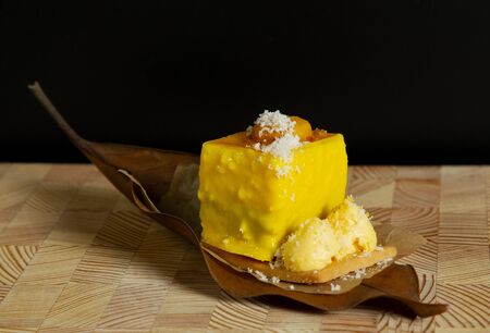 beautiful stylish new yellow cake on an autumn leaf