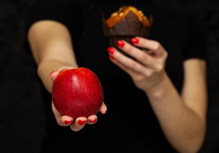 girl holds an apple in her hand and offers healthy a food, healthy nutritionの写真素材