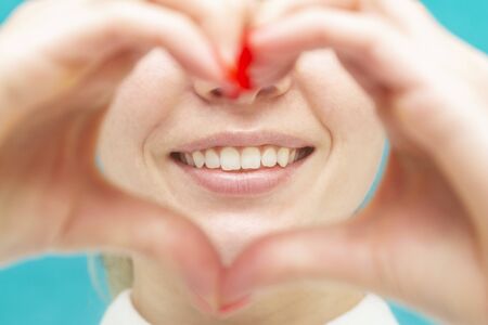 beautiful smile in the heart made by hands, love for healthy teeth, clean mouth