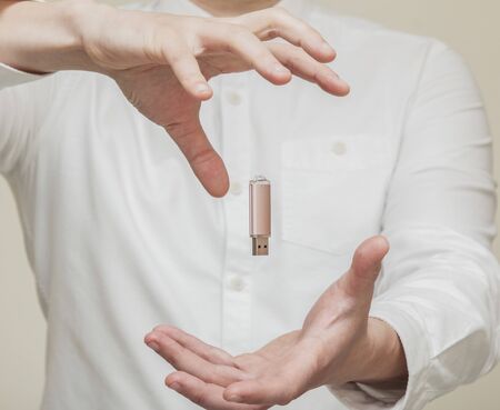 memory card, usb levitation on the background of human handsの写真素材