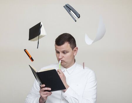 office worker in a white shirt levitates office items