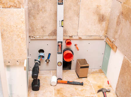 a construction repair tools on the background of stone natural tiles