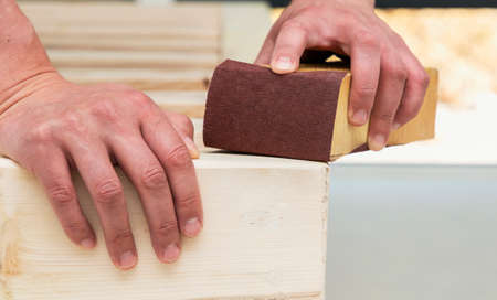 a man makes a wooden bed with his own hands, hand madeの写真素材