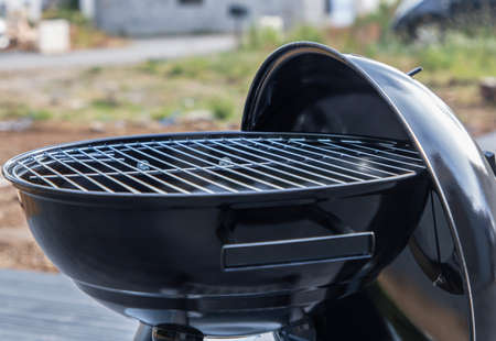 Black barbecue grill isolated on the terrace with compositeの写真素材