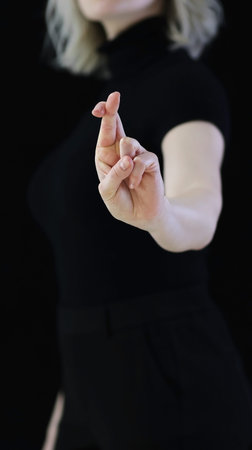A beautiful crossed finger sign against the evil eye, from conspiracies against bad peopleのeditorial素材