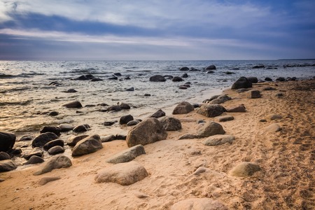 Rocky Baltic sea and cloudy sky background.
