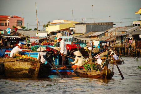 Floating market on the Mekong river with the fruits, flowers and vegetablesの写真素材