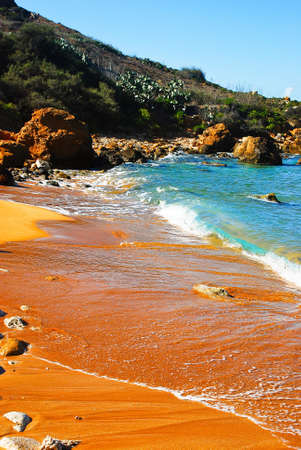 Rocky shore and red sand San Blas Beach in Nadur Gozoのeditorial素材
