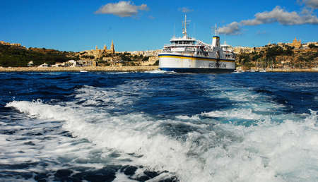 Mgdarr port with the ferry to the Comino Islands and city in backgroundのeditorial素材
