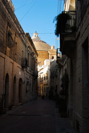 Mosta street with the view on the Mosta Rotunda in the backgroundの写真素材