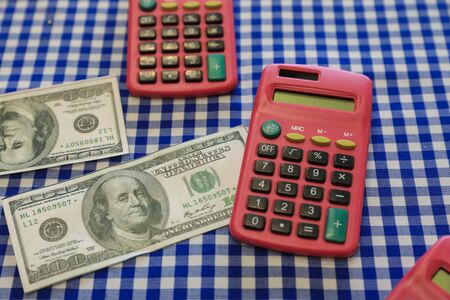 $ 100 bills and calculators on a table. Finances, Business, Economy.の写真素材