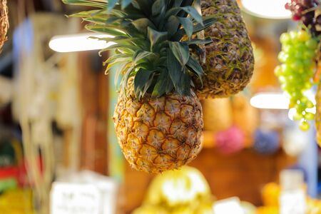 Ripe whole pineapple at market.の写真素材