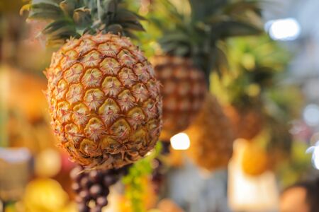 Ripe whole pineapple at market.の写真素材