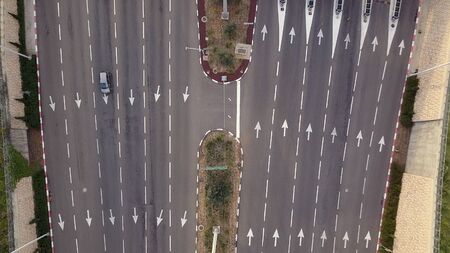 Aerial view of multi lane road with arrow symbol.