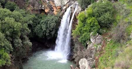 High waterfall and greenery all around.の写真素材