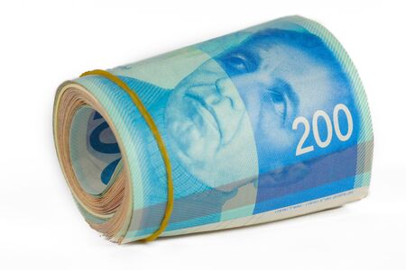 Bunch of 200 Israeli New Shekels (NIS) bills rolled together with a rubber band.の写真素材