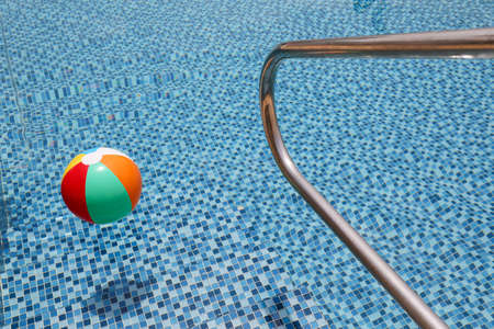 Grab bars ladder in a blue swimming pool.の写真素材