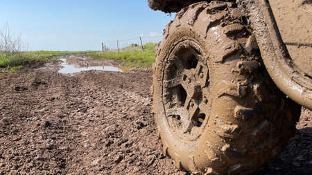 ATV wheels are full of mud. Travel and adventure concept.