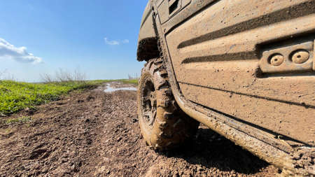 ATV wheels are full of mud. Travel and adventure concept.