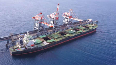 Bulk container ship unloads coal in the port of power station.の写真素材