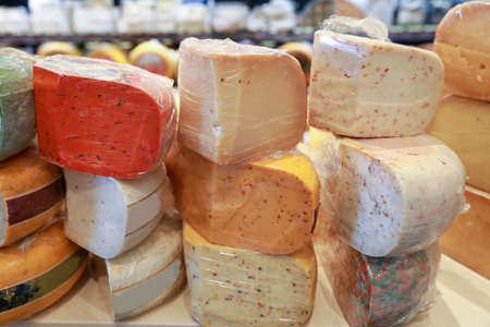 Several types of hard cheeses are for sale in a deli.の写真素材