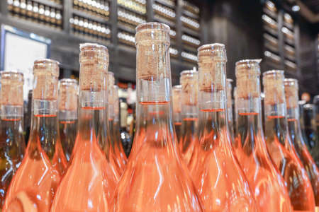 Several alcoholic beverage bottles in a liquor store.
