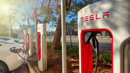 Haifa, Israel - February 6, 2022: Tesla cars while charging at Tesla supercharger Station. Tesla Charging point.のeditorial素材