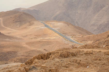 Winding Road on a mountainside in the desert, Dead Sea Israel.の写真素材