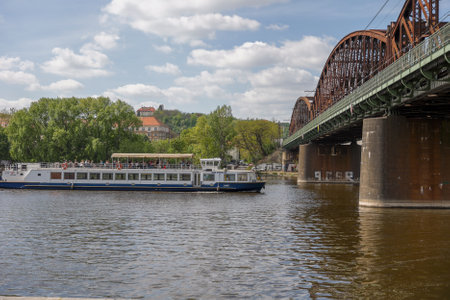 River view featuring a cruise ship alongside a beautiful bridgeの写真素材