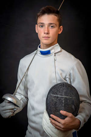 a young man in a swordsman's ammunition with a sword in a cook