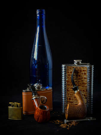 staging with a blue bottle, smoking pipes, flasks and an ashtrayの写真素材