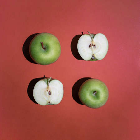 Minimalistic square composition of fresh organic green apples. Geometric food composition, contemporary flat lay arrangement.の写真素材