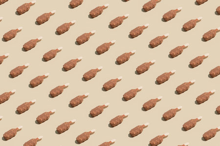 Minimalistic summer vibes pattern idea with sweet chocolate ice cream on pastel beige background. Creative tasty dessert concept, aesthetic geometric composition.の写真素材