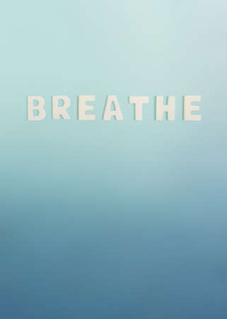 Minimal concept with word breathe on pastel blue background. Aesthetic vertical arrangement, creative graphic idea.の写真素材