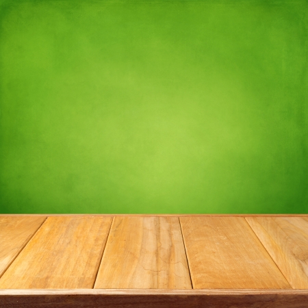 Summer background with wooden empty table and green grunge wallpaperの写真素材