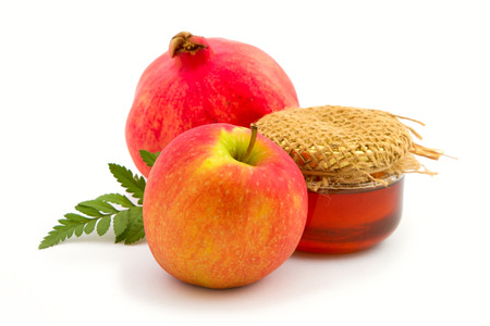Apple, honey and pomegranate on white background.の写真素材