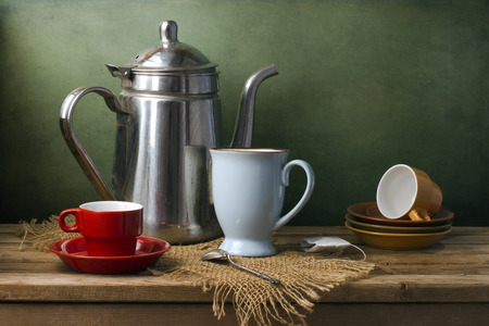 Still life with teapot and cups on wooden tableの写真素材