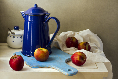 Still life with enamel vintage jug and fresh applesの写真素材