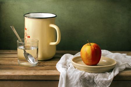 Still life with fresh apple and enamel jugの写真素材