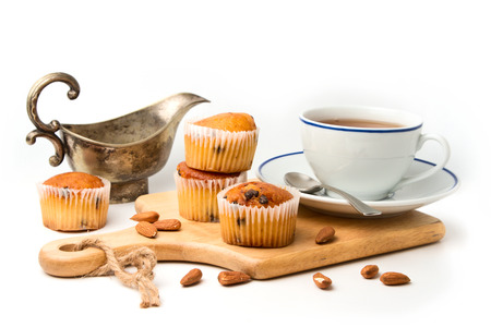 Muffins on wooden cutting board on white backgroundの写真素材
