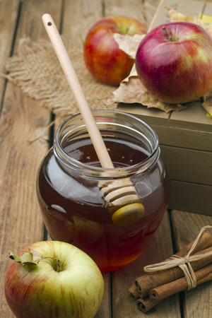 Honey and apples on wooden tabletopの写真素材
