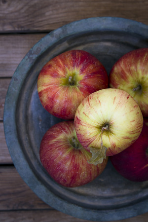 Fresh red apples on metal vintage plateの写真素材